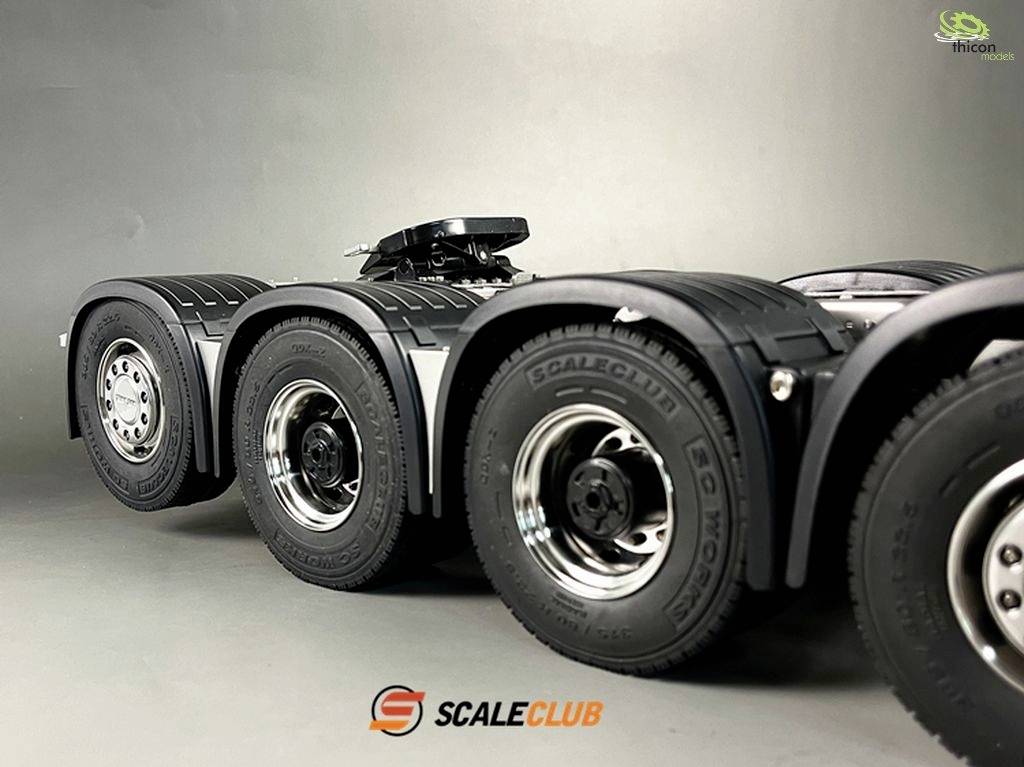 A model low-loader lorry with multiple axles and detailed tyres, captured from the side profile.