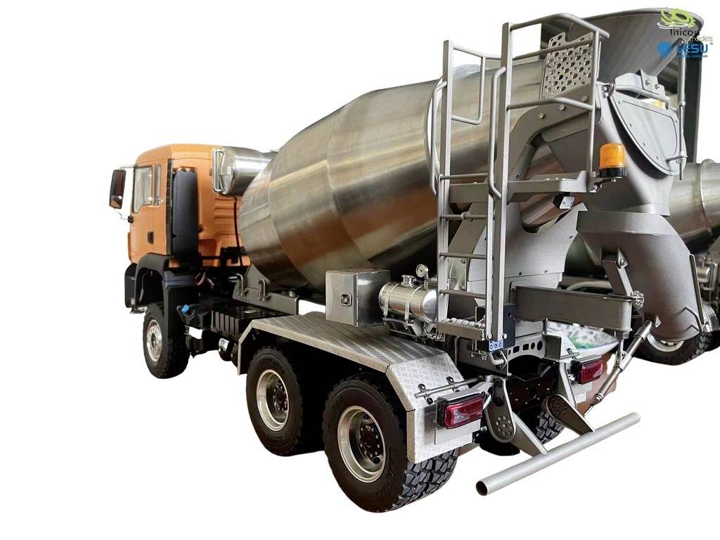 A concrete mixer lorry with a large, silver drum and an orange cab is positioned sideways.