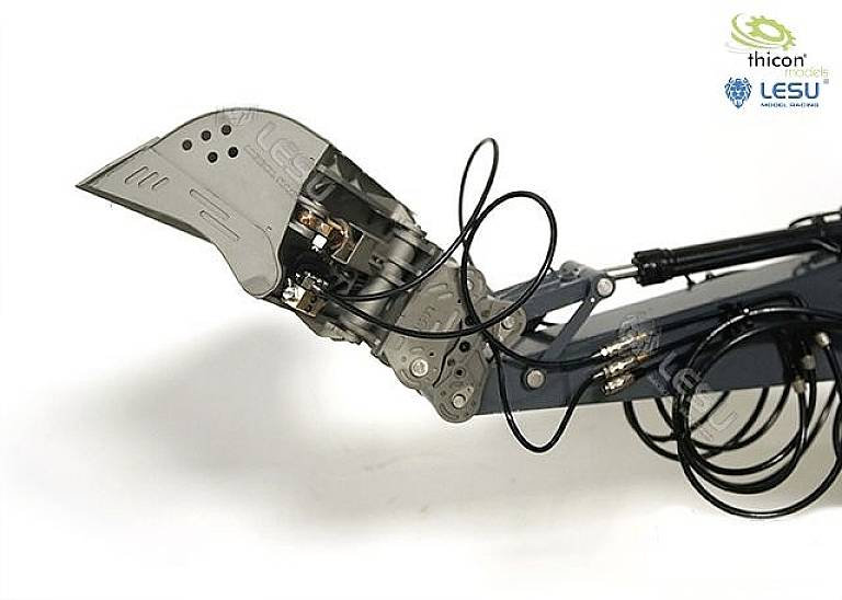 A metallic excavator arm with a bucket and hydraulic lines shows a close-up of the mechanical structure.