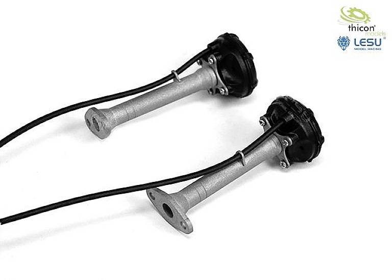 Two model exhausts with cables, manufactured from metal, are lying side by side on a white background.
