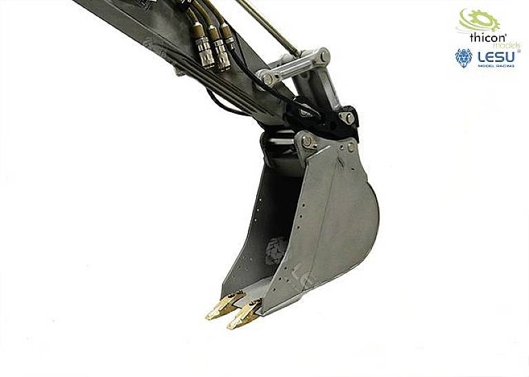 Close-up of an excavator bucket with two teeth. Some hoses are visible at the top. Two logos are located in the top right corner.