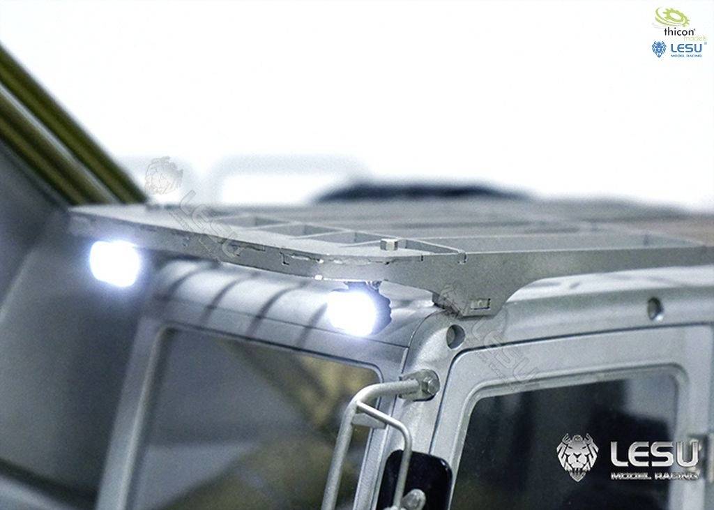 Close-up of a model lorry with an illuminated roof rack. Brand logos 'ithoor' and 'LESU' are visible.