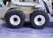 Toy tractor with four wheels on a blue background. The tyres are black with silver rims, and the 'LESU' brand is visible.