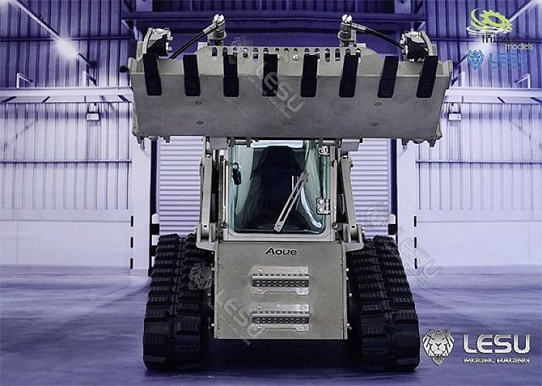 Compact, remote-controlled metal tracked excavator in a warehouse; designed by LESU, with robust tracks and large front bucket.