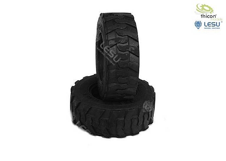 Two black and grey tyres with coarse tread patterns on a white background, one standing upright, the other lying down. Models by Thicon and Lesu.