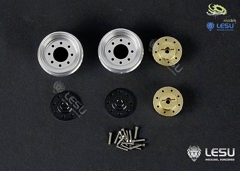 'Four model wheel rims made of metal and plastic in silver, black and gold, with screws, shown against a black background.'