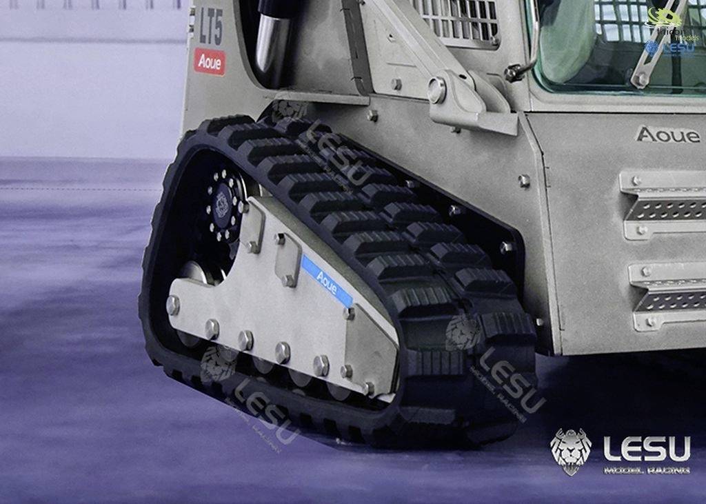 'Close-up of a machine's tracked undercarriage with robust rubber tracks. The brand 'Aoue' is visible on the vehicle.'