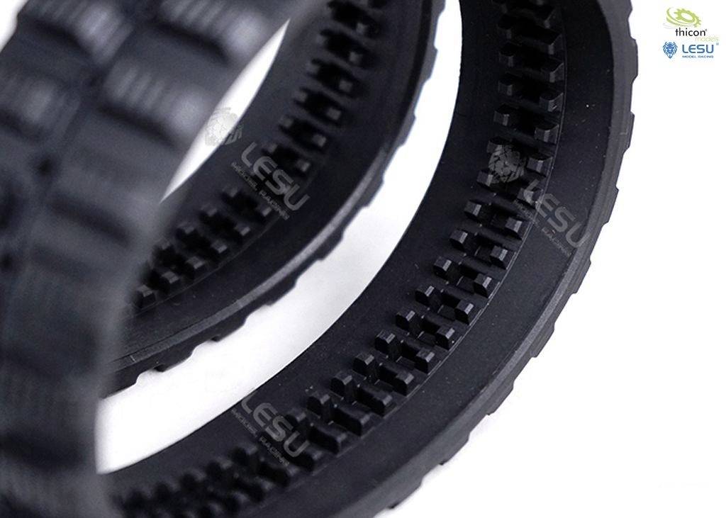 Close-up of two black timing belts with fine teeth and a textured surface, against a white background.