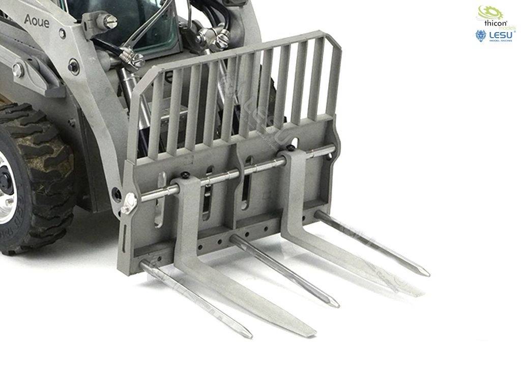 Close-up of a metal fork from a small industrial machine model with robust tines, suitable for agricultural work.