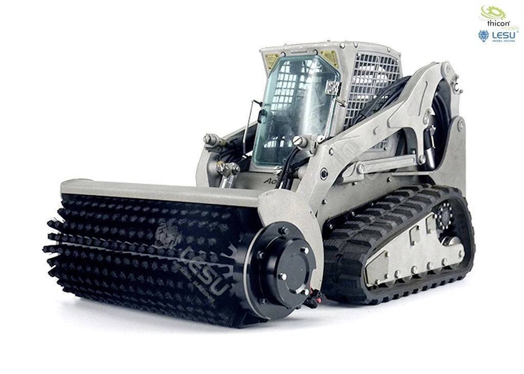 A grey chain excavator with a forward-facing bucket fitted with spikes. It stands against a light grey background.