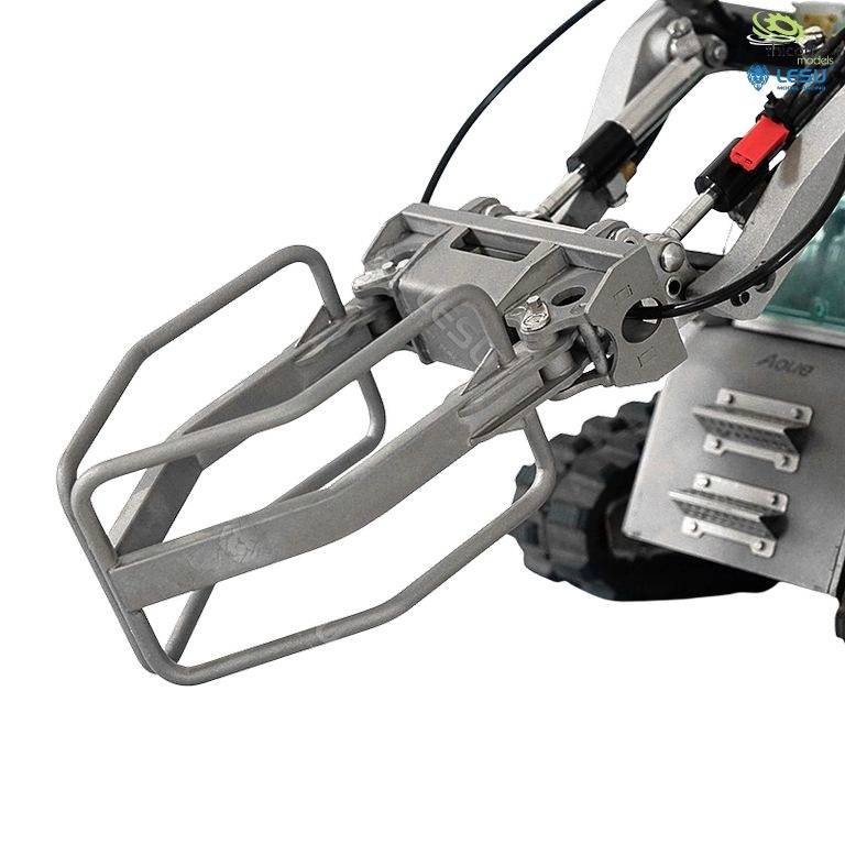 A small metal robot with a robotic arm and wheels, designed for precise tasks. The arm is in an extended position.