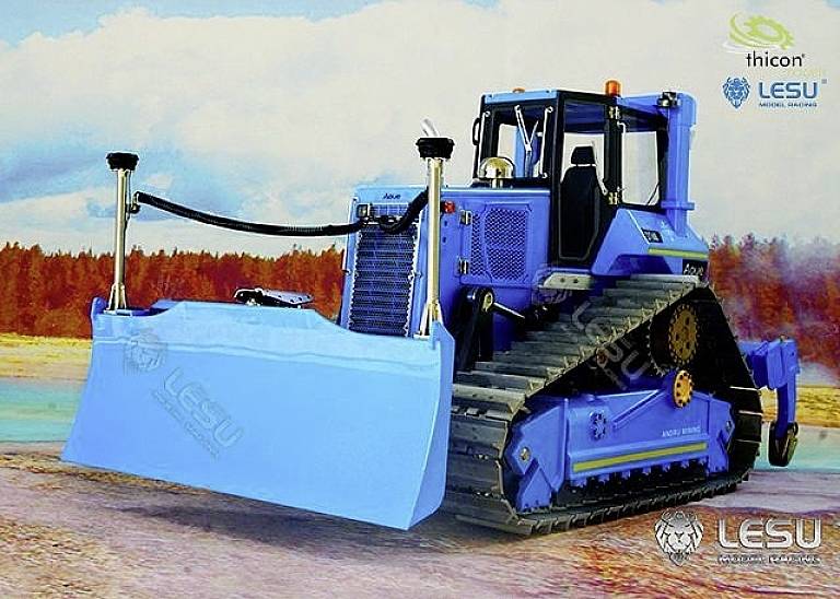A blue bulldozer with tracked chassis is standing outside against a woodland backdrop, with a large sign at the front indicating earthworks.