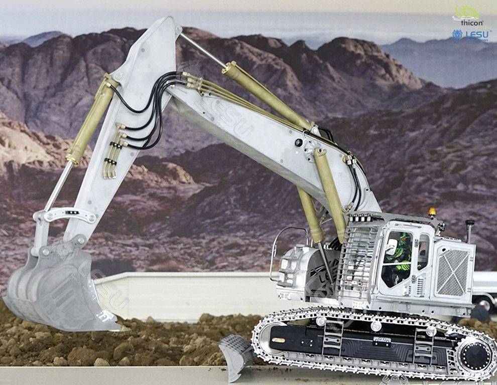 A large excavator is working the earth on a construction site in hilly terrain. Rocky hills are visible in the background.
