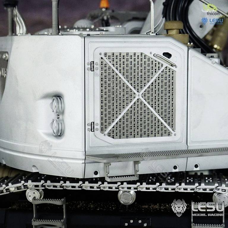 A silver industrial cooling container with ventilation grille and tank connections, mounted in a technical environment.