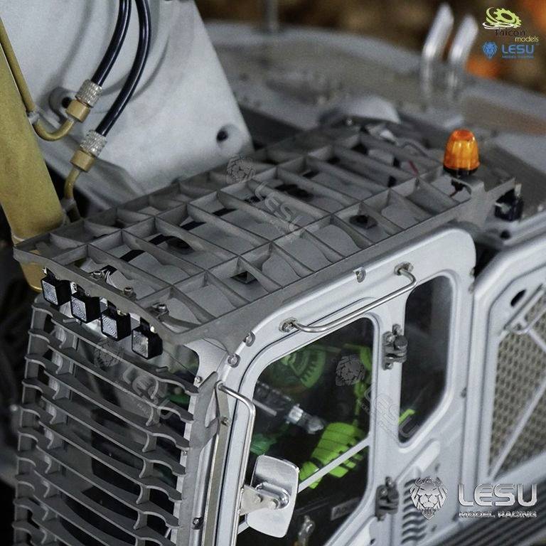 Close-up of a metal model of a technical vehicle with intricate grid and lamp design.