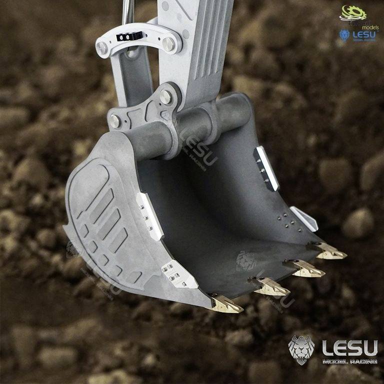 An excavator arm digs into the ground with a metallic bucket. Brand names are visible on the arm.