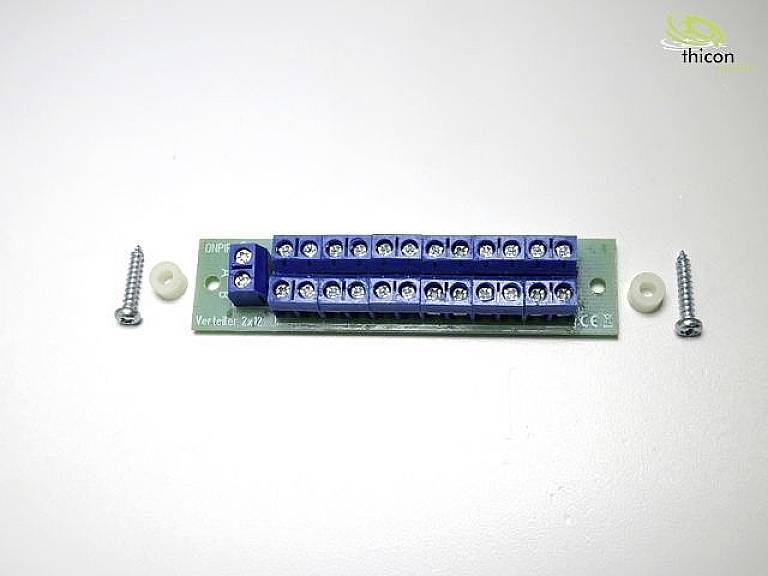 Green circuit board with a blue distribution rail '2x17', flanked by two screws and wall plugs on a light background.