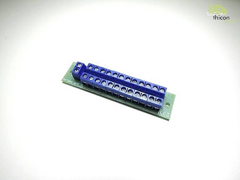 A green printed circuit board with two rows of blue screw terminals, suitable for electrical connections. A logo is positioned in the top right corner.