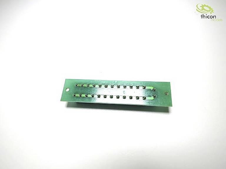 Green printed circuit board with multiple soldered pins; used for electrical connection of electronic components. Logo in top right corner.