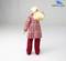 Doll with blonde hair in a plait, wearing a red checked coat and red trousers, standing with raised arm, 'WEDICO-models' logo in top right corner.