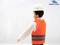 Toy figurine in a work vest and hard hat, viewed from the side.