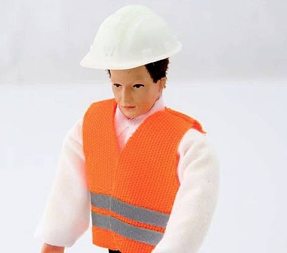A toy figure is wearing a white hard hat and an orange high-visibility vest.