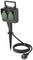 A black garden power socket on a ground spike, with two green socket outlets and a long cable with a Schuko plug.