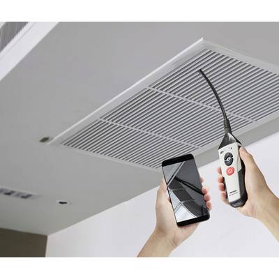 A person is checking the interior of a ventilation shaft on the ceiling using an endoscope camera and smartphone.