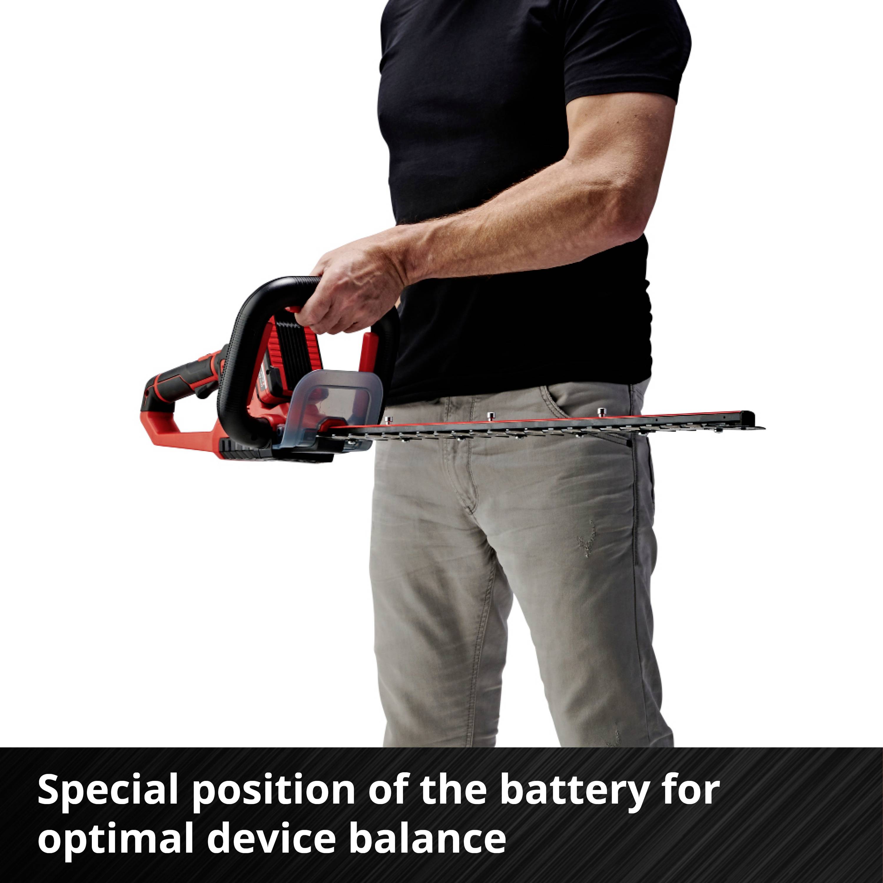 A person is holding a chainsaw with a red handle in their right hand. Below it reads: 'Special battery positioning for optimal device balance'.