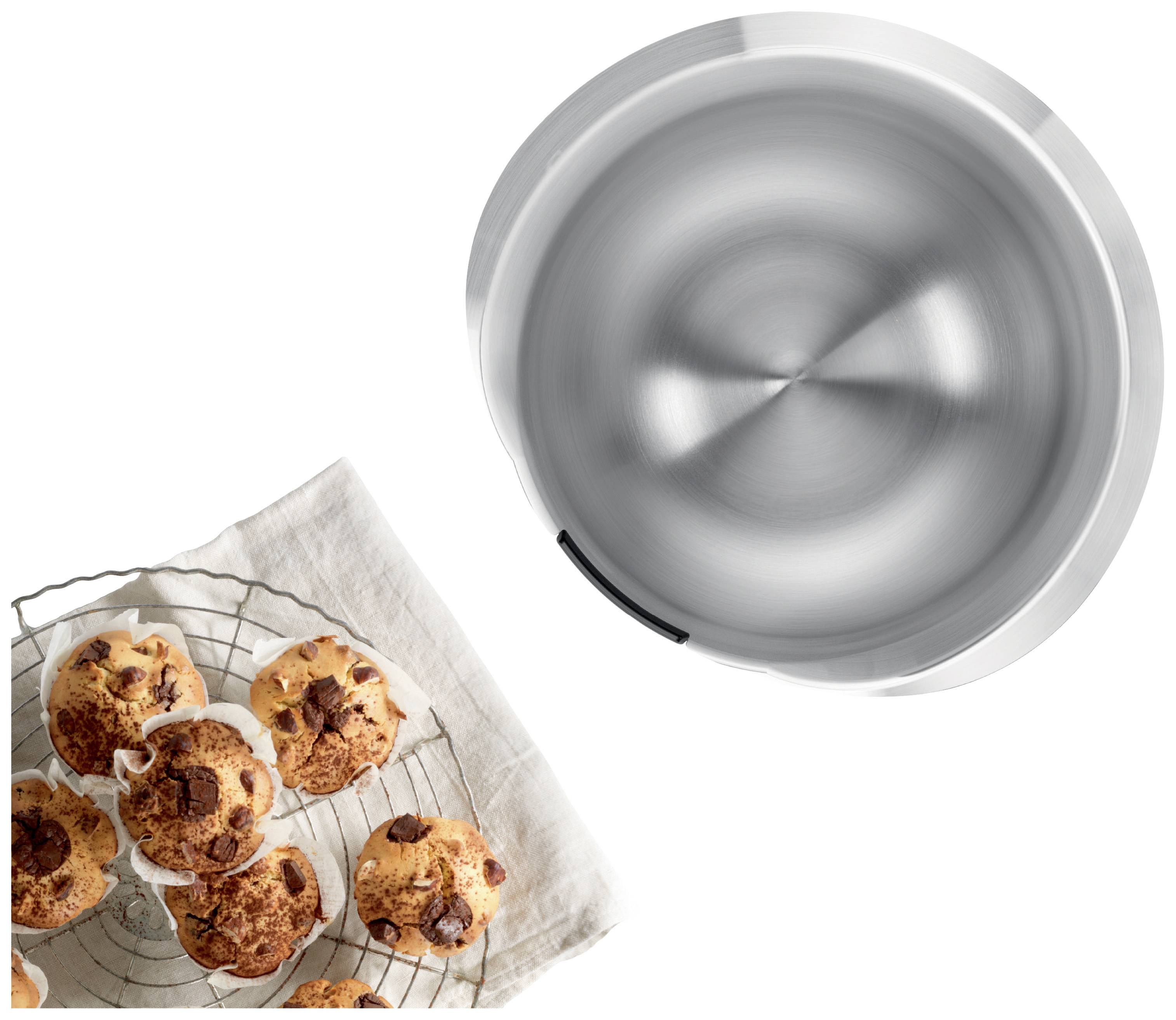 Metal bowl with a smooth, circular surface in the top right; biscuits on a wire rack with a linen cloth underneath, located on the left bottom.