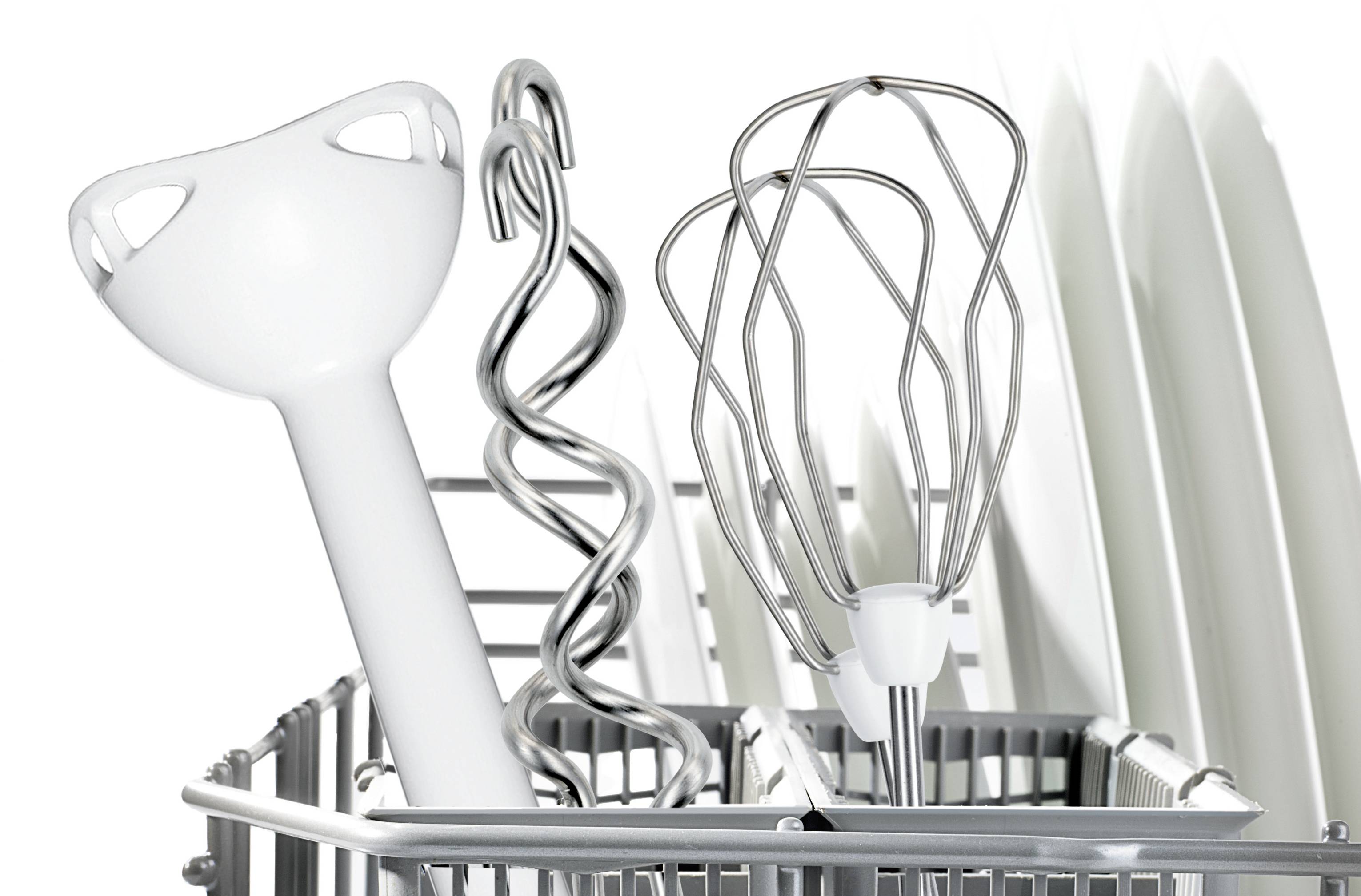 Kitchen utensils in the dishwasher rack: a hand blender, dough hook and whisk arranged in front of white plates.