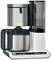 Coffee machine with glass carafe, water tank and digital display, showing 10:30.