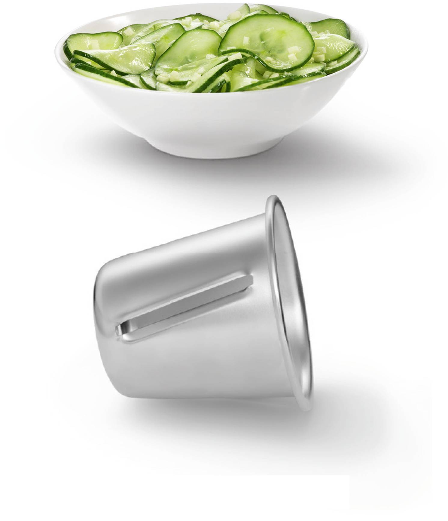 A white bowl filled with cucumber salad and a grater lying on its side.
