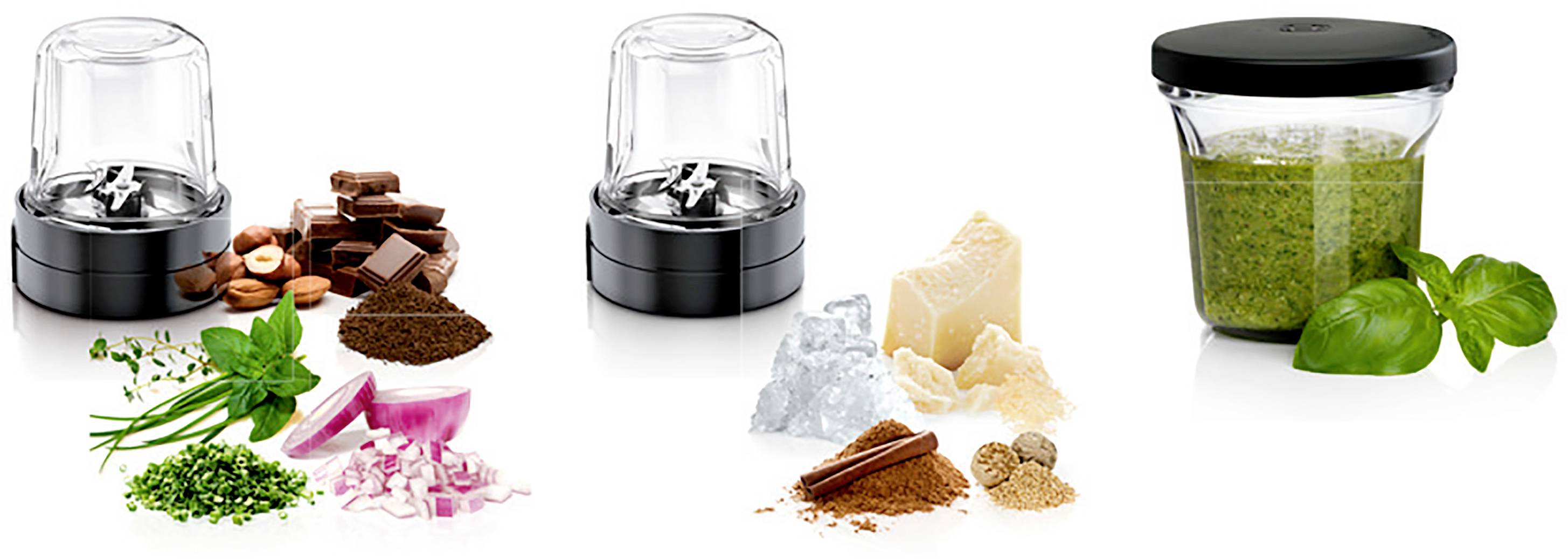 Three spice mills with various ingredients: herbs, chocolate, onion; next to a glass of green pesto and basil.