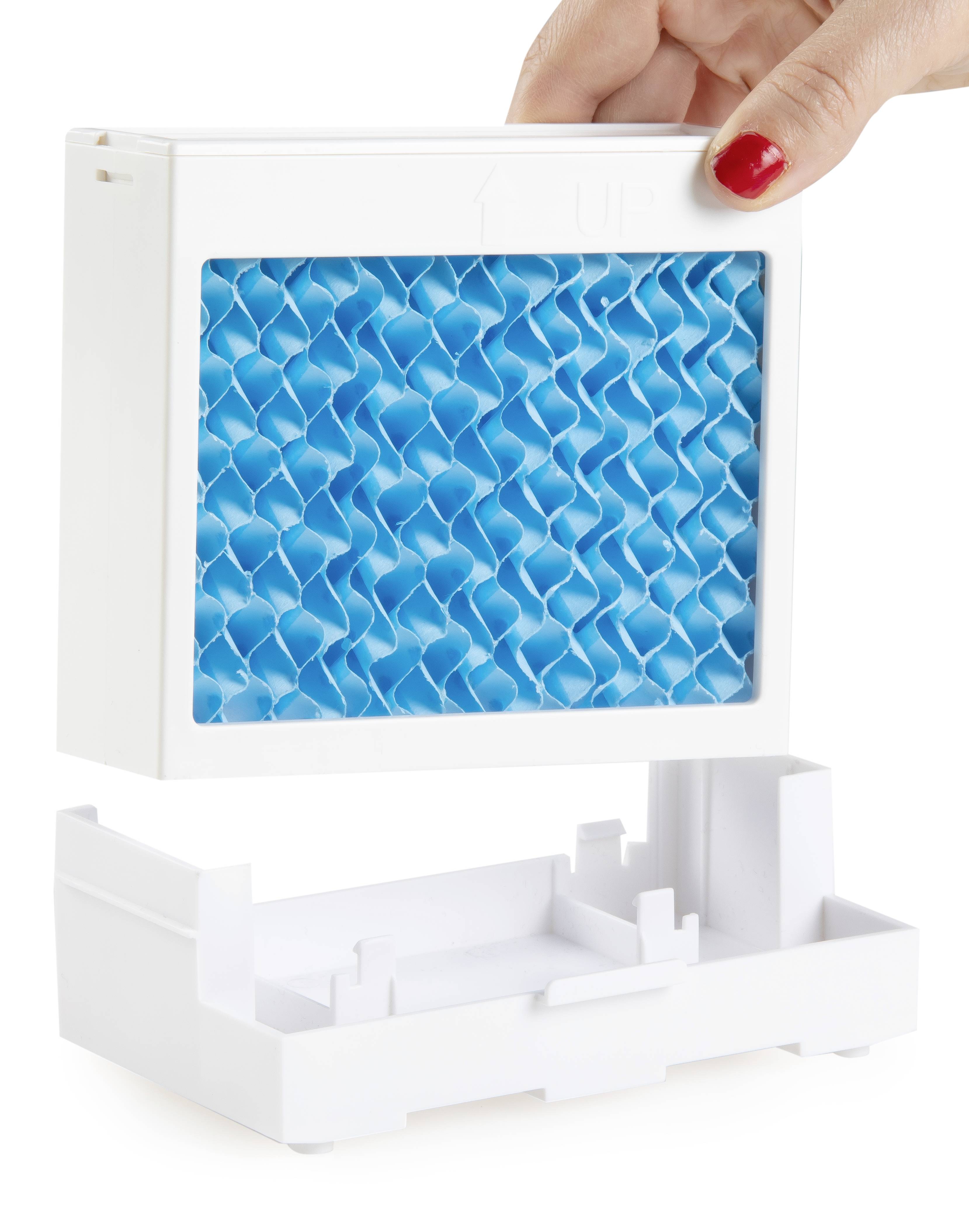 A hand lifts a blue air filter from a white housing. The filter has a honeycomb-like structure.