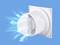 A white ventilation fan mounted on a blue surface. Air currents are shown leaving the fan.