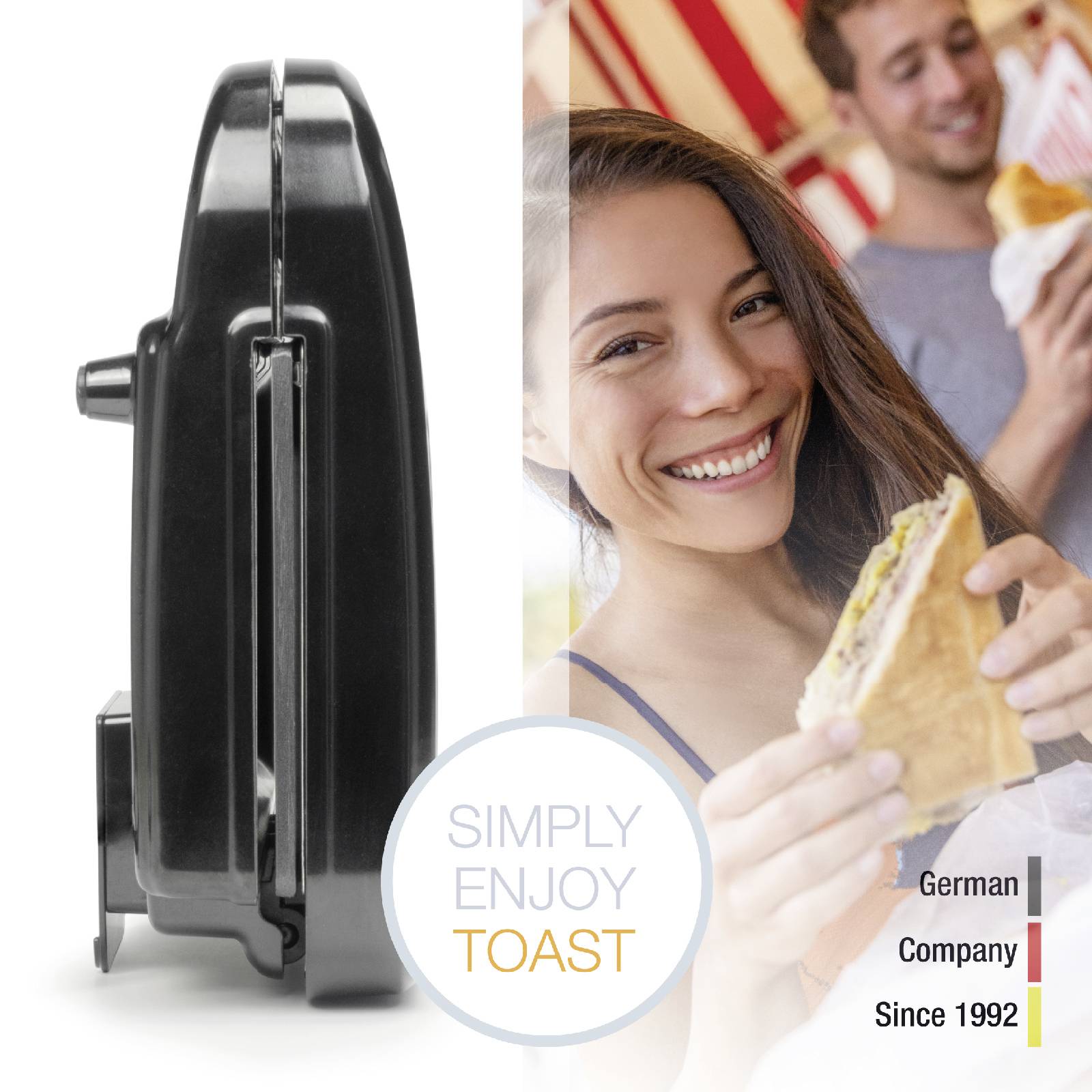 A young woman is smiling and holding a sandwich. Next to her is a black toaster with the inscription 'Simply enjoy toast'. In the background, people are engaged in a cheerful conversation.