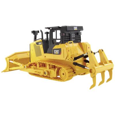 A yellow toy bulldozer with caterpillar tracks and a shovel, CAT model, stands with details such as a small radiator grille and lever arms.
