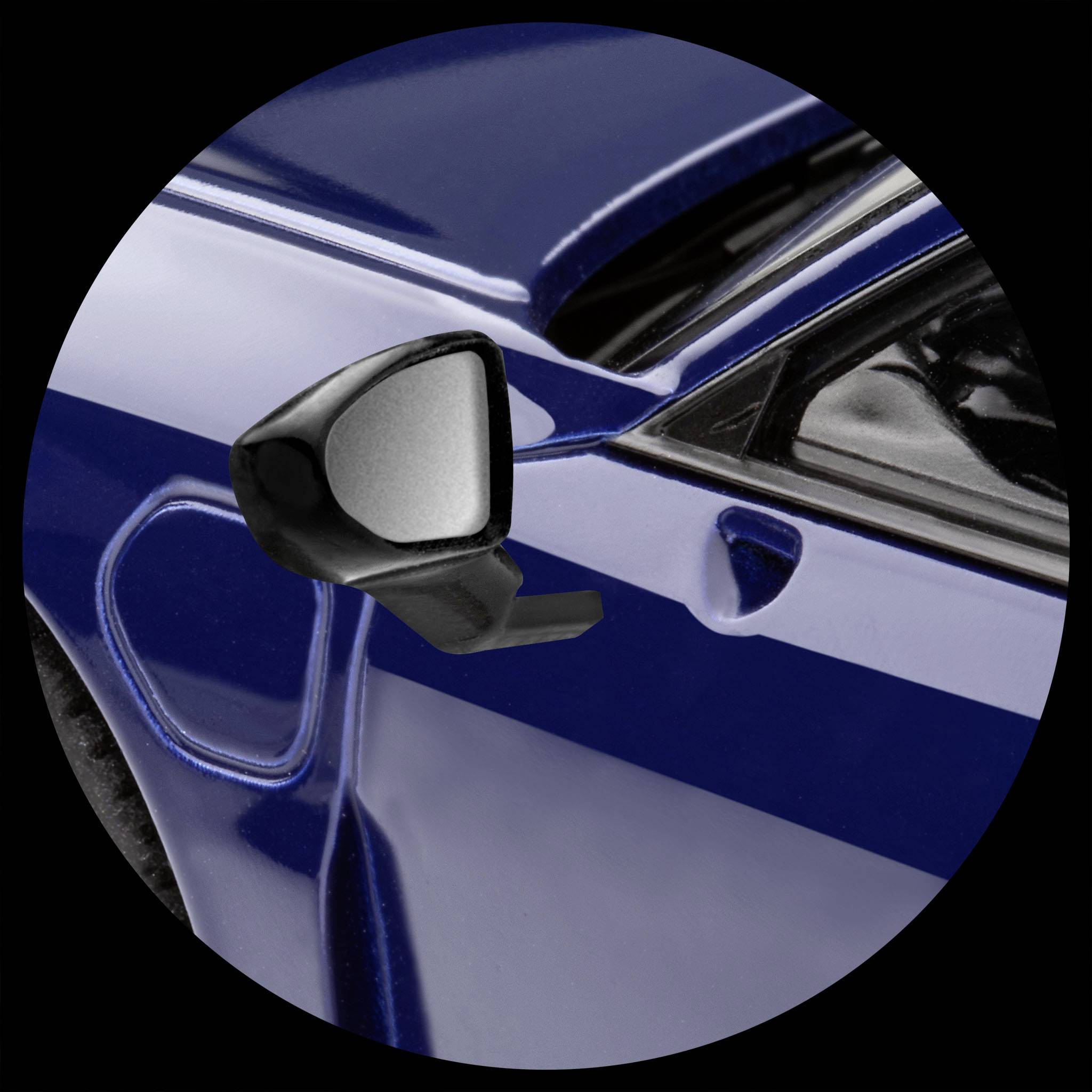 Close-up of a side car wing mirror of a blue car, partially obscured by the bodywork.