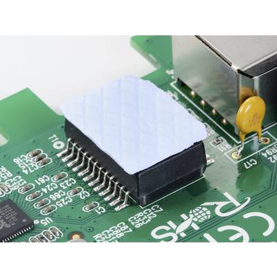 A close-up of a green circuit board with an integrated circuit, partially covered by a blue heatsink.
