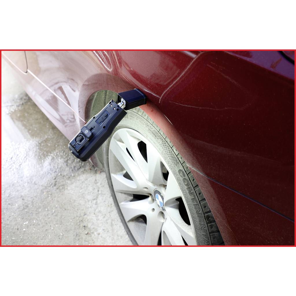 A red car with a diagonal parking scrape on the rear wing above the tyre. Damage clearly visible.