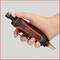 A hand is holding a red and black pneumatic tool from the brand 'KS Tools', ready for use.
