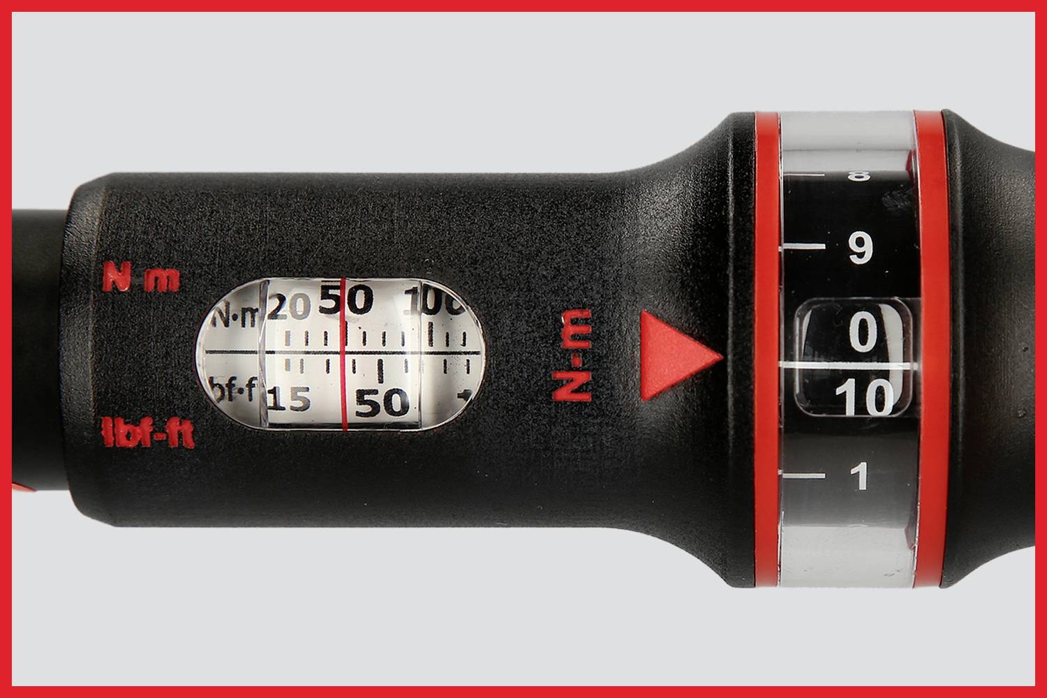 Torque wrench display with scale for newton metres and foot-pounds. Reduction arrow indicates direction.
