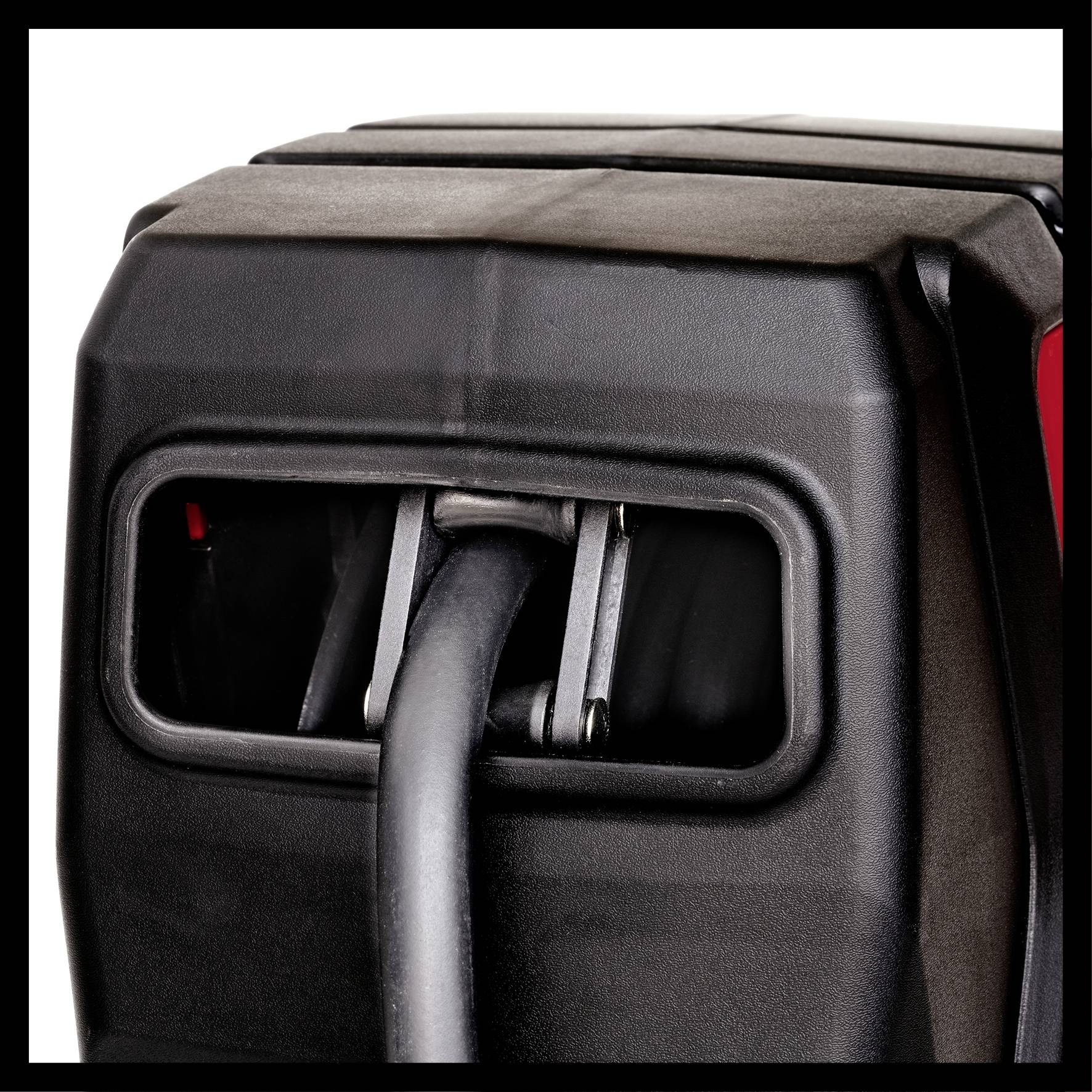 A black electronic device shows an outstanding plug protruding from a rectangular socket.