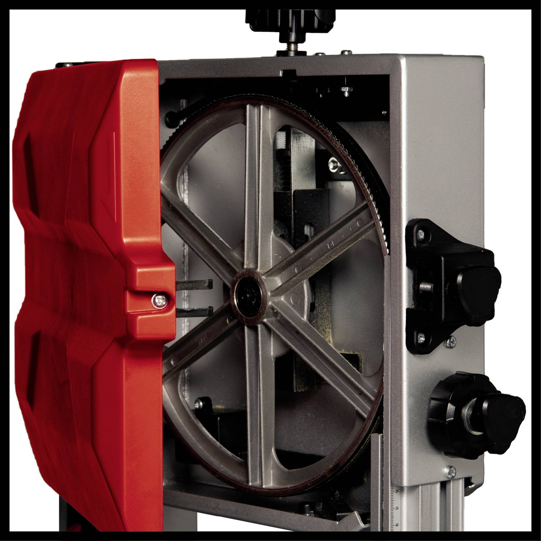 Opened bandsaw with visible wheel and red casing, showing technical details of the saw's construction.