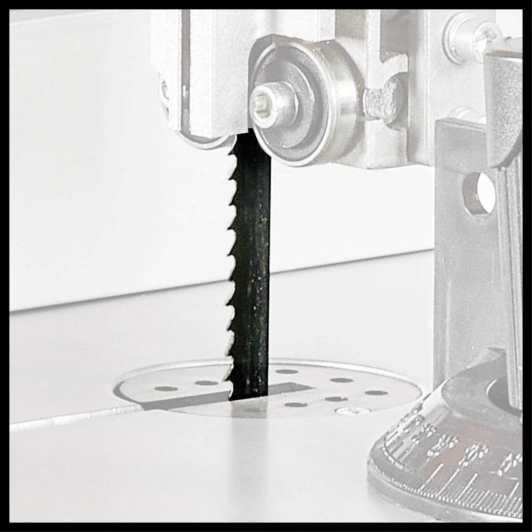 Machine saw blade in use, cutting through material on a smooth surface.