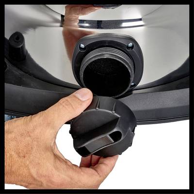 A hand closes the lid on a metal opening.