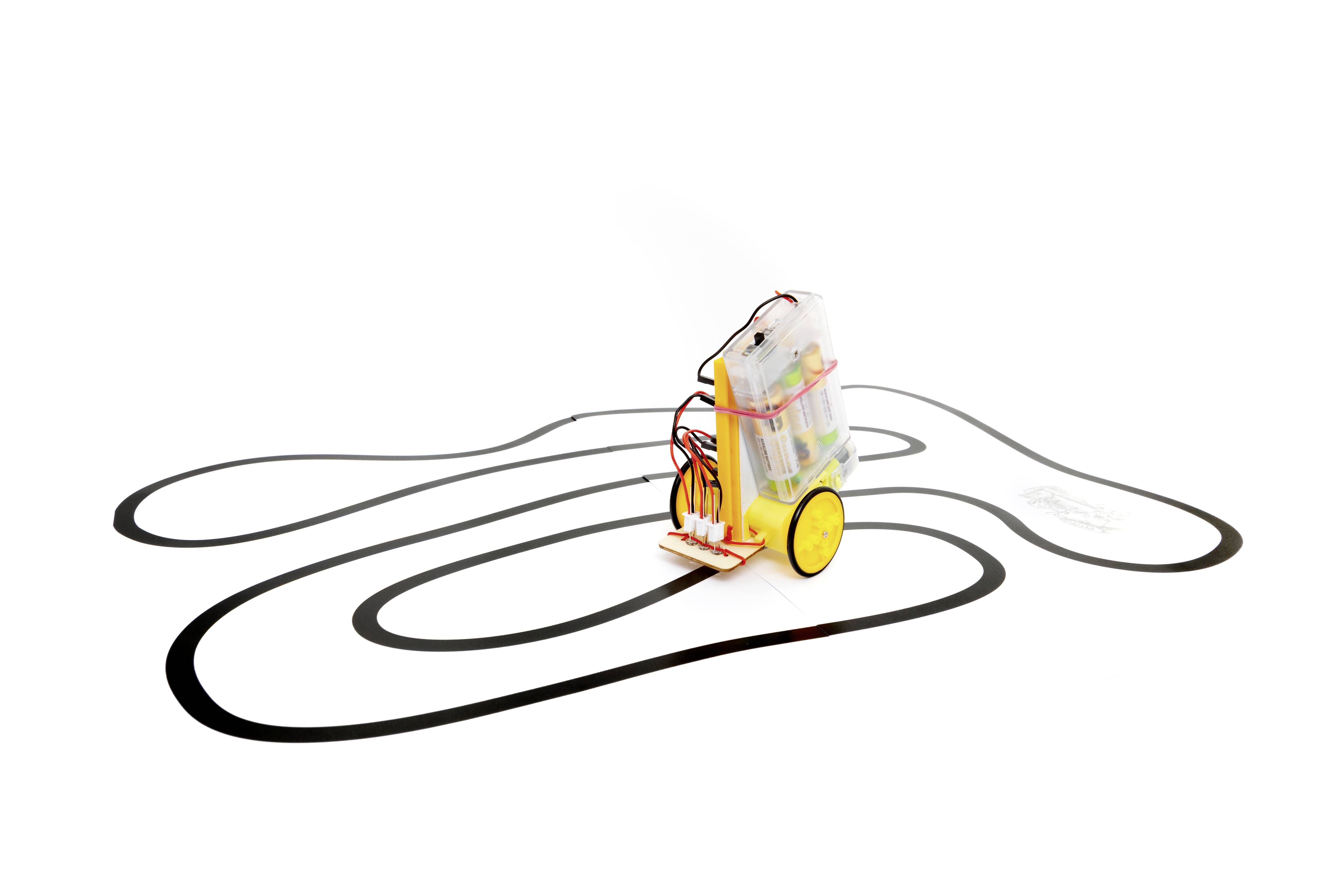 A small robot follows a black line on a white surface. The robot carries electronic components and batteries.