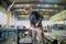 A person is working with an angle grinder in a large, well-lit workshop; sparks are flying as metal is being cut.