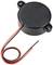 Electronic buzzer with a round, black housing and two cables, one red and one black.
